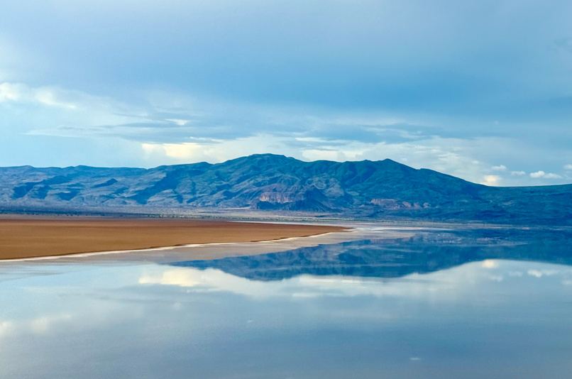 Lake Logipi with mountains reflected in the water