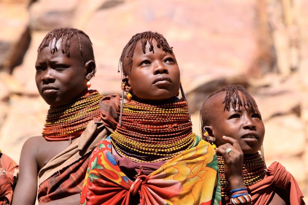 Turkana women and girls in traditional beaded necklaces